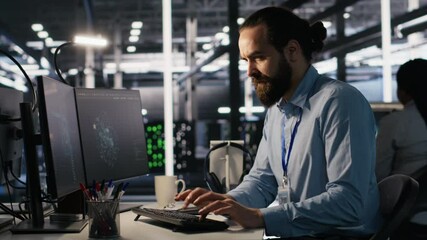 Server room IT specialist frustrated by difficult complex tasks in office. Stressed engineer developing neural network software while working extended hours in data center, camera A