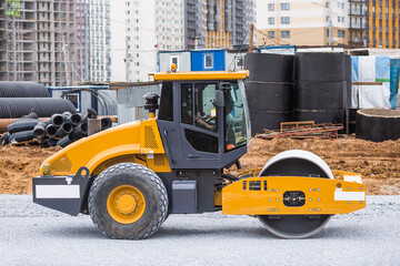 Heavy machinery for excavation and landscaping. Close-up of a road roller at a construction site. The skating rink rolls away the rubble. Road construction.