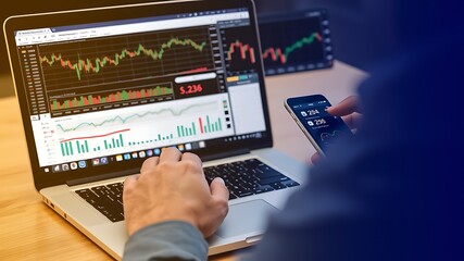 Fototapeta premium Analyzing stock market charts on laptop and smartphone to make financial decisions