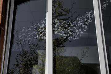 window covered with musical notes