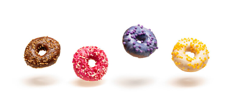 Isolated image of bright appetizing glazed donuts floating in the air.