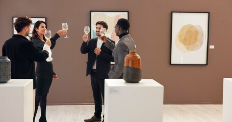 People, art and toast with champagne at gallery for event success, celebration and auction goals. Men, woman and cheers with wine glass for sculpture sales, artwork collection and expo negotiation
