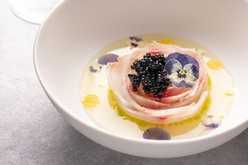 A traditional dish in Peru, ceviche, elegant appetizer of fresh fish in lime sauce leche de tigre, black caviar