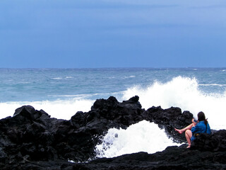 Woman relaxing on Sao Miguel Island coast.