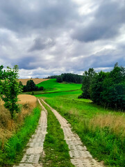 Obraz premium Dark clouds over meadow in Kashubia. Rainy weather coming.