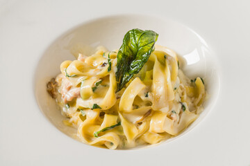 Top view of Fettuccine Alfredo on dark grey stone table