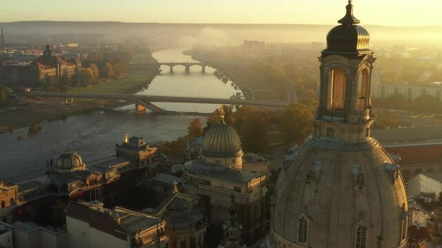 Drone video of a picturesque island on the Elbe River near Dresden, Germany, featuring a church and lush greenery. A peaceful and spiritual location surrounded by water and nature.