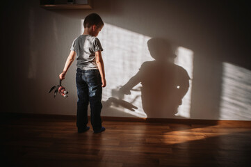 Little boy lonely depressed standing with back sitting on floor sad autism. autism spectrum disorder, psychological problems, mental health. child with a soft toy in his hands horror © illustrissima