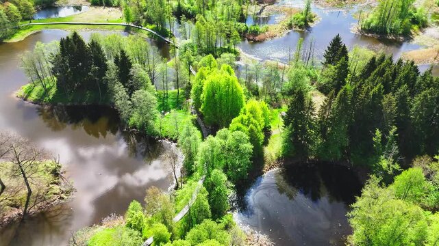 From Kirkilai Tower, a Picturesque Landscape of Winding Boardwalks, Calm Karst Lakes, and Lush Forest Unfolds in Biržai Regional Park, Lithuania - Aerial Drone Shot