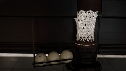 Playing Russian billiards. A middle billiard pocket full of white balls. A successful shot close...
