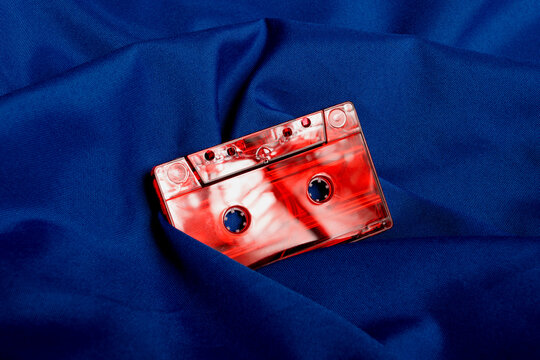 Vintage red cassette tape on blue quilt