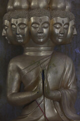 Multi-faced Asian god, close-up statue