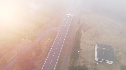 Aerial cityscape with vehicle driving in dense fog