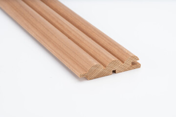 Decorative wooden trim piece with a scalloped profile, made from medium-toned wood, isolated on white background for product presentation..
