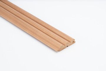 Decorative wooden trim piece with a scalloped profile, made from medium-toned wood, isolated on white background for product presentation..