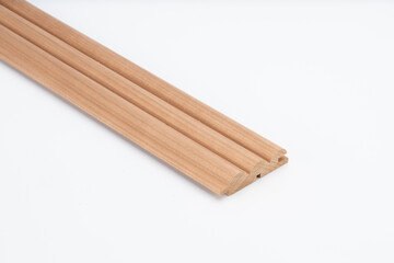 Decorative wooden trim piece with a scalloped profile, made from medium-toned wood, isolated on white background for product presentation..