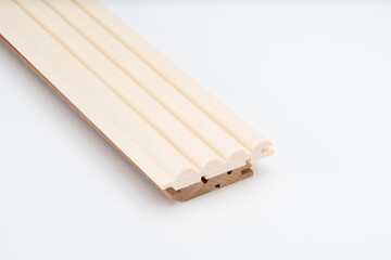 Profiled light wood molding piece with decorative ridges and tongue-and-groove joints, shown on a white background for product display..