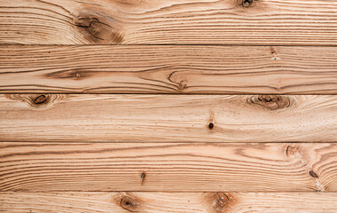Wooden planks arranged horizontally showing wood grain and knots in a close-up.