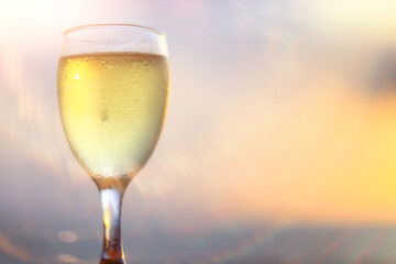 A glass of white wine on a blurred abstract background, alcohol, relaxation