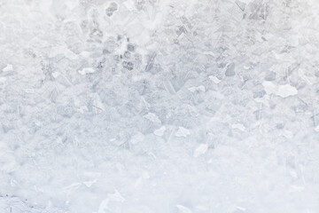 white winter background, frosty patterns on glass, abstract backdrop of ice and snow crystals in a...