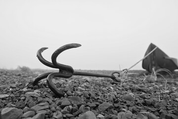 Wooden boat with an old anchor on the river, northern Russian landscape
