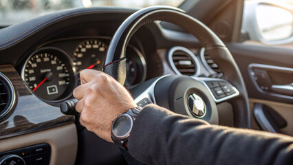 Close-up of driver&rsquo;s hand turning ignition, dashboard details. Generative AI. 