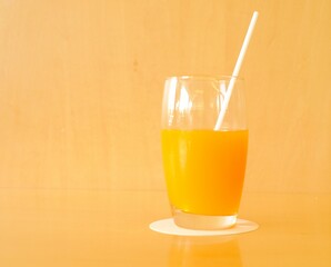 Fototapeta premium a glass of orange juice on the table 