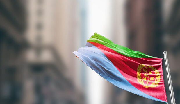 Eritrea national flag waving on street. A beautiful with mast with blur buildings. Eritrea national flag for independence day.