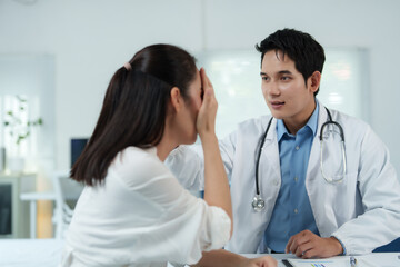 Doctor comforting crying patient in medical office