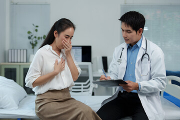 Doctor visiting sick patient in hospital room taking notes