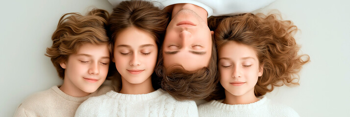 Happy family lying on the floor with closed eyes in cozy sweaters and peaceful expressions