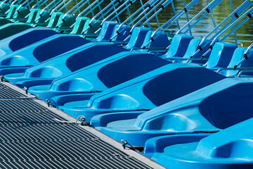 Colorful paddle boats lined up on the dock at the lake