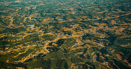 View From Airplane Window On Private Buildings, China. Mountainous Wooded Terrain Landscape Of...