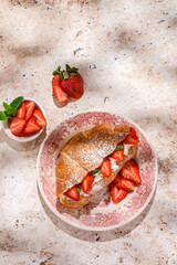 croissant with strawberries and mascarpone and cheesecakes with strawberries