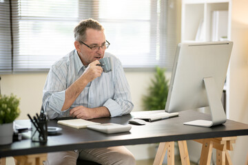 Fototapeta premium A businessman is sitting at his desk working.
