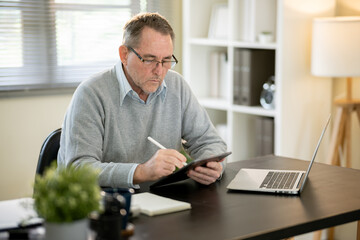 Fototapeta premium A businessman is sitting at his desk working.