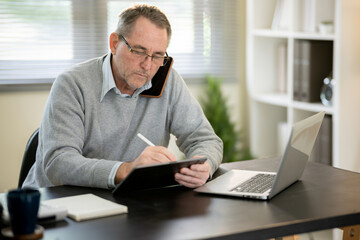 A businessman is sitting at his desk working.