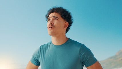 Man, outdoor and thinking of fitness with fatigue, catching breath and tired at sky space. Runner,...