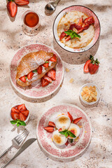 cottage cheese cheesecakes with strawberries, croissant and porridge with strawberries. breakfast...