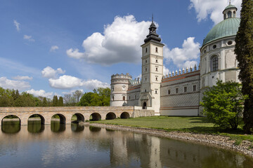 View of 17th century Krasiczyn Castle and arcaded bridge over pond in castle park, Krasiczyn, Poland
