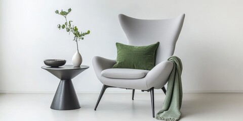 Fototapeta premium Interior of living room. Gray armchair, green pillow, coffee table and beige wall. Velour Chair against light wall, wooden floor, parquet. Home improvement. Beautiful luxurious modern room settings.