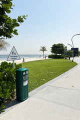 Dog-friendly beach in Dubai Islands with clean green lawn, pet waste station, and modern infrastructure. Peaceful place for pets and owners to relax by the sea