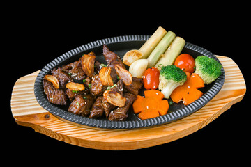 Japanese garlic beef stir fry with vegetables on sizzling hot plate