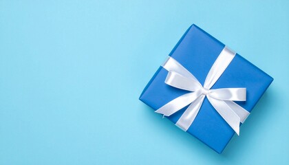 Elegant blue gift box adorned with white ribbon symbolizing joy and celebration