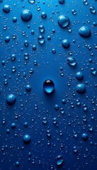 A blue background adorned with numerous water droplets, with a prominent larger drop at the center. 