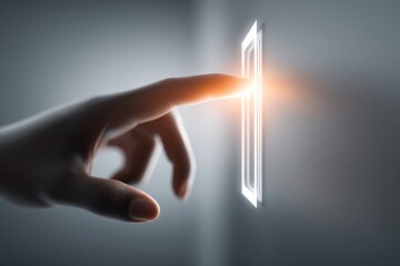 Hand pressing a control panel in a dimly lit space emphasizing technology and interaction at night