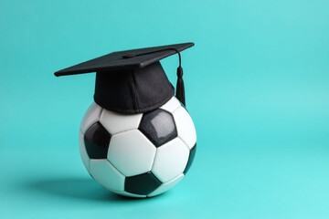soccer ball with a graduation cap on top of it