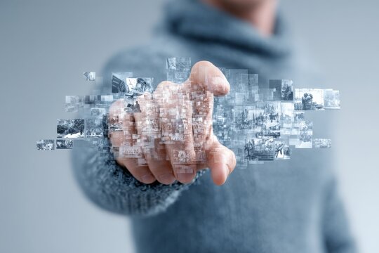 Fingers interact with virtual images displaying dynamic moments in technology and creativity at an indoor setting