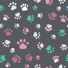 Seamless vector pattern with multicolored paw prints on dark gray background for pet-themed fabric or wallpaper