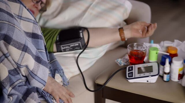 Unhealthy woman checking blood pressure hypotension diagnostic on medical tonometer	